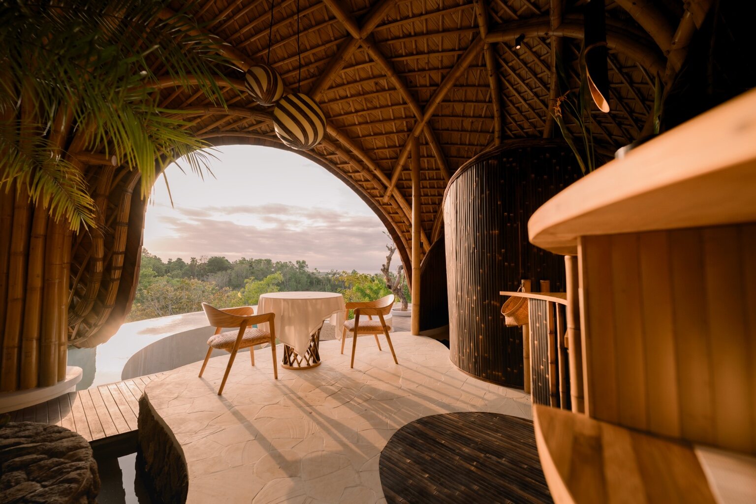 Private dining table for two beneath The Orca bamboo roof, overlooking the valley