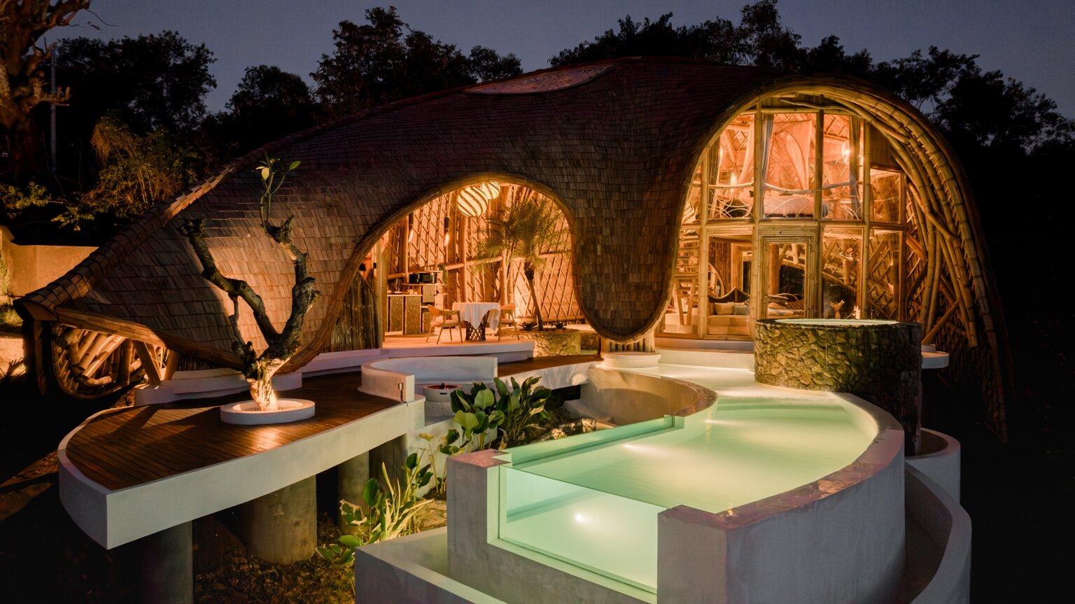 The Orca bamboo sanctuary and private pool illuminated at night